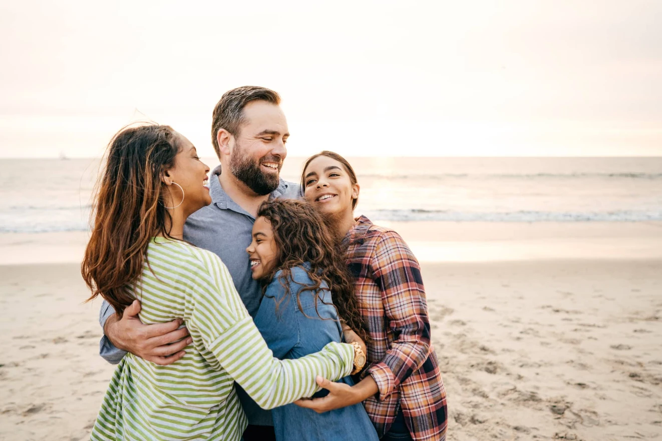 A happy family gathering together on a beach